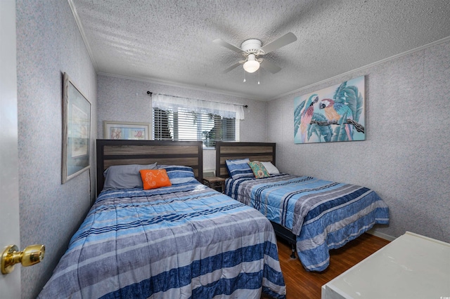 bedroom with ceiling fan, a textured ceiling, crown molding, and dark wood-type flooring