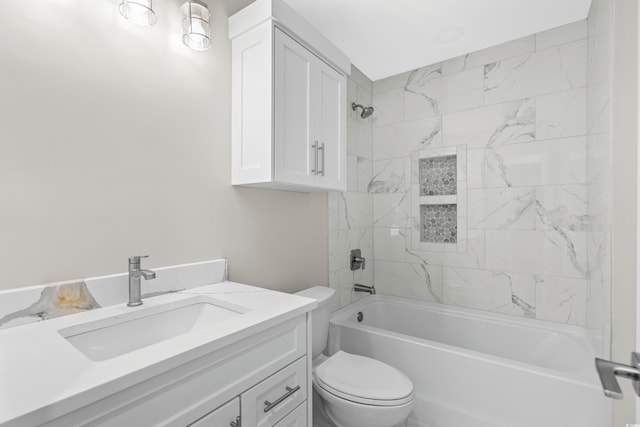 full bathroom with vanity, tiled shower / bath combo, and toilet