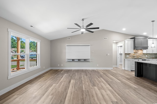 unfurnished living room featuring ceiling fan, light wood-type flooring, and lofted ceiling