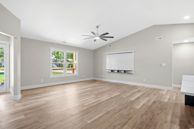 unfurnished living room featuring vaulted ceiling, light hardwood / wood-style flooring, and ceiling fan