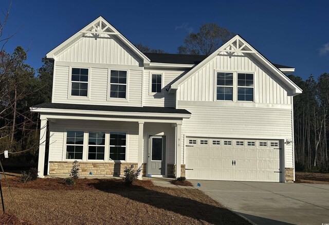 craftsman-style home with a garage and a front lawn