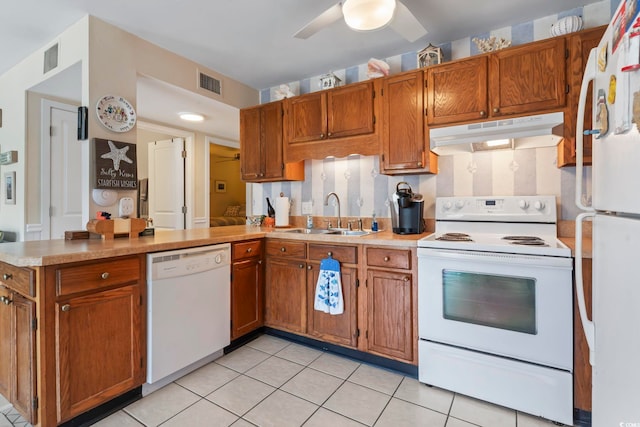 5905 S Kings Hwy Unit 219-B, Myrtle Beach, SC 29575 - kitchen with white appliances, under cabinet range hood, a peninsula, and brown cabinetry