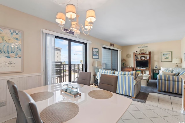 5905 S Kings Hwy Unit 219-B, Myrtle Beach, SC 29575 - dining room featuring a chandelier, light tile patterned flooring, and a wainscoted wall