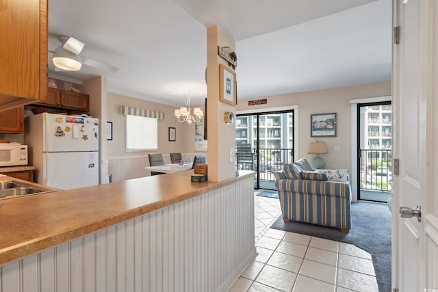 5905 S Kings Hwy Unit 219-B, Myrtle Beach, SC 29575 - kitchen featuring white appliances, plenty of natural light, open floor plan, and light tile patterned floors