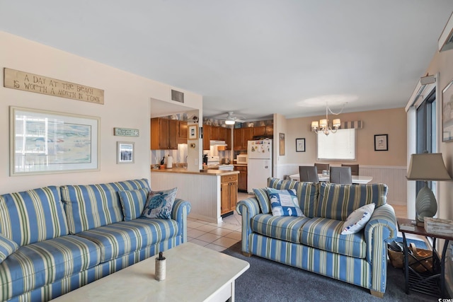 5905 S Kings Hwy Unit 219-B, Myrtle Beach, SC 29575 - living area with a chandelier, a wainscoted wall, light tile patterned floors, and a ceiling fan