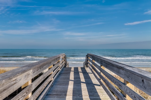 view of property's community with a beach view and a water view