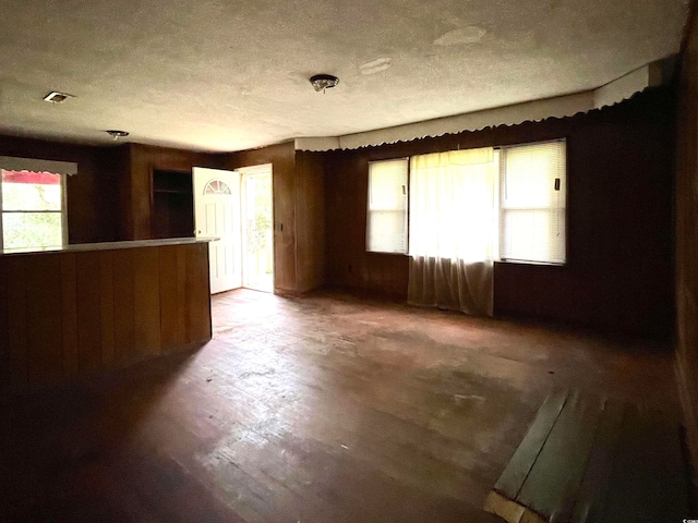 spare room featuring a textured ceiling and dark wood-type flooring