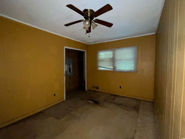 empty room featuring ornamental molding, ceiling fan, and electric panel