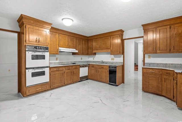 kitchen featuring a textured ceiling, sink, and white appliances