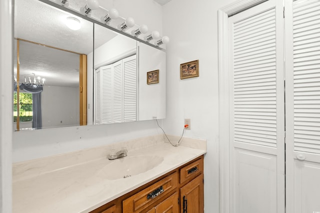 bathroom featuring a textured ceiling and vanity