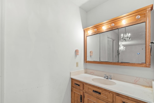 bathroom featuring vanity and a notable chandelier