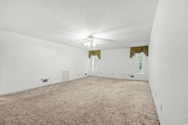 carpeted empty room with a textured ceiling and ceiling fan