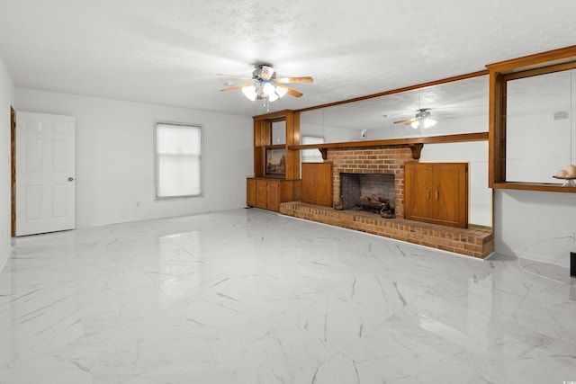 unfurnished living room with ceiling fan, a textured ceiling, and a brick fireplace