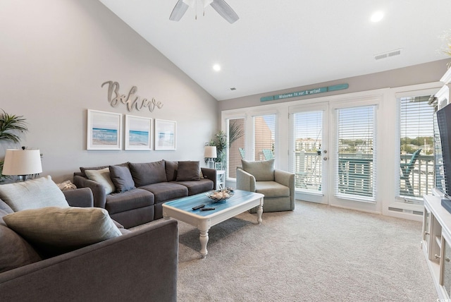 carpeted living room featuring ceiling fan and high vaulted ceiling