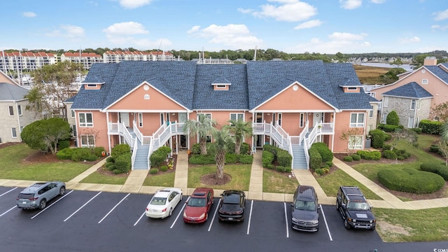 4755 Lightkeepers Way Unit 15-F, Little River, SC 29566 - view of front facade with stairway, a porch, and uncovered parking