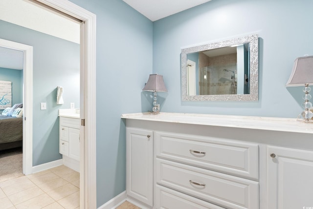 bathroom featuring vanity, tile patterned flooring, and a shower with door