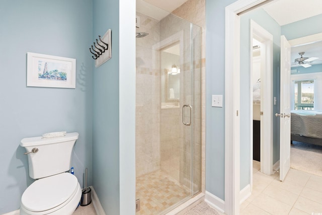 bathroom with tile patterned flooring, an enclosed shower, ceiling fan, and toilet