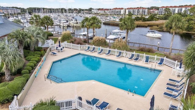 view of pool with a water view and a patio area