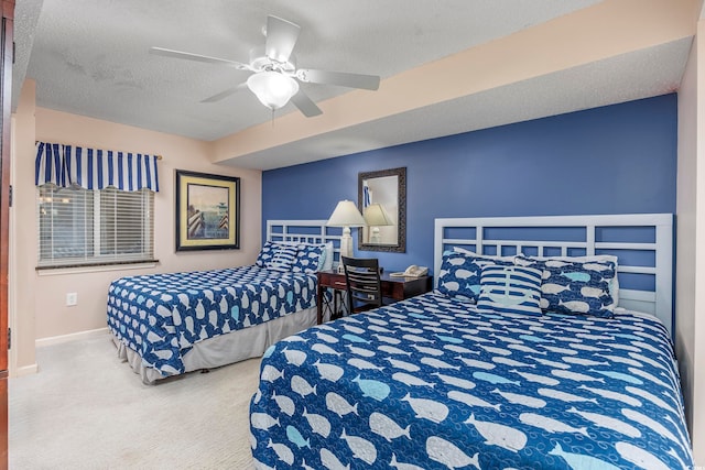 carpeted bedroom with ceiling fan and a textured ceiling