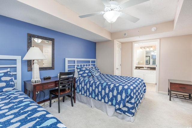 bedroom with light carpet, connected bathroom, ceiling fan, and a textured ceiling