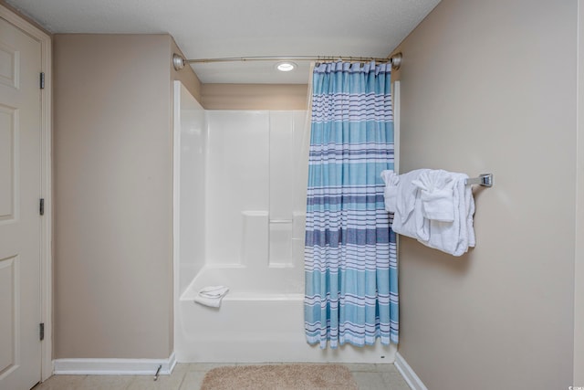 bathroom with shower / tub combo with curtain and tile patterned flooring