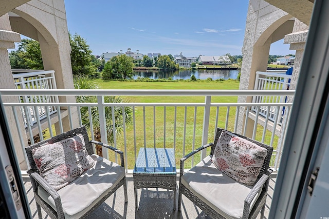 balcony featuring a water view