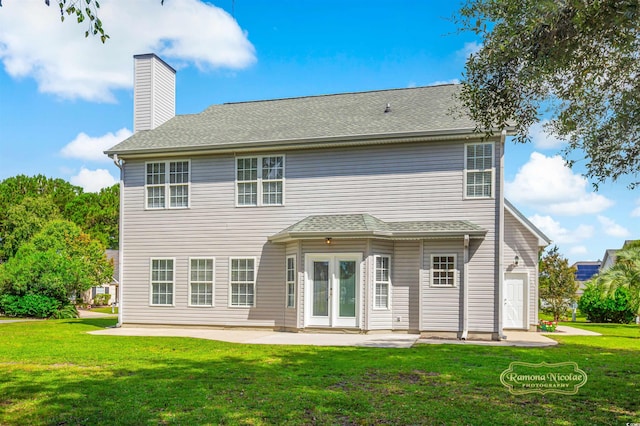 rear view of house featuring a lawn and a patio