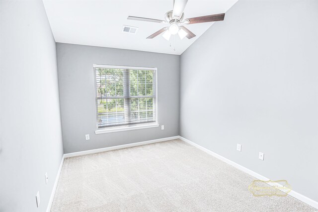 empty room featuring ceiling fan, light colored carpet, and lofted ceiling