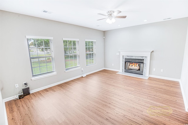 629 Slash Pine Ct, Myrtle Beach, SC 29579 - unfurnished living room featuring ceiling fan, light wood-style floors, a high end fireplace, and baseboards