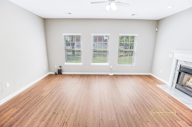 629 Slash Pine Ct, Myrtle Beach, SC 29579 - unfurnished living room featuring a ceiling fan, a high end fireplace, light wood-style flooring, baseboards, and recessed lighting
