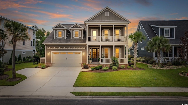 craftsman house featuring a lawn, a balcony, a porch, and a garage