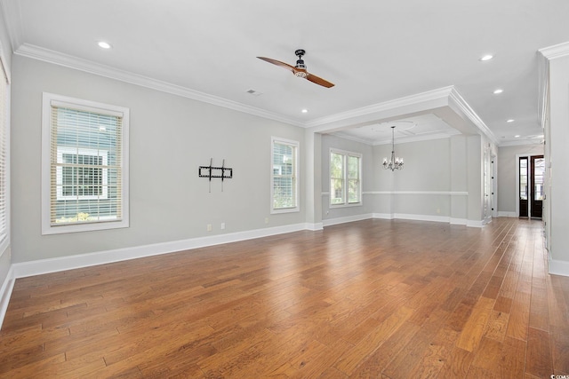 unfurnished living room with hardwood / wood-style flooring, ceiling fan with notable chandelier, and ornamental molding