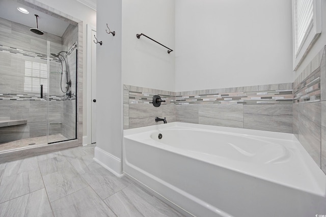 bathroom featuring shower with separate bathtub