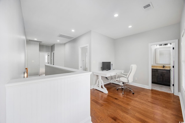 office space featuring sink and hardwood / wood-style flooring