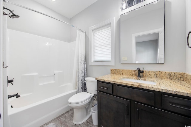 full bathroom with shower / bath combination with curtain, hardwood / wood-style floors, vanity, and toilet