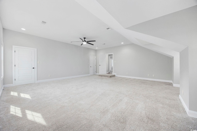 additional living space with lofted ceiling, ceiling fan, and light colored carpet