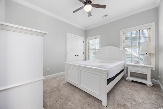 bedroom with ornamental molding, ceiling fan, and light colored carpet