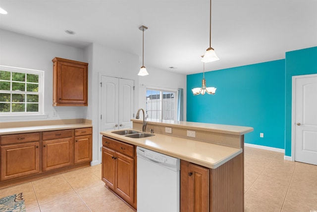 kitchen featuring light tile patterned flooring, an island with sink, dishwasher, decorative light fixtures, and sink