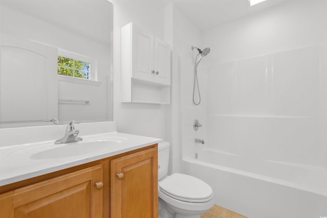 bathroom featuring toilet, tile patterned floors, vanity, and shower / washtub combination