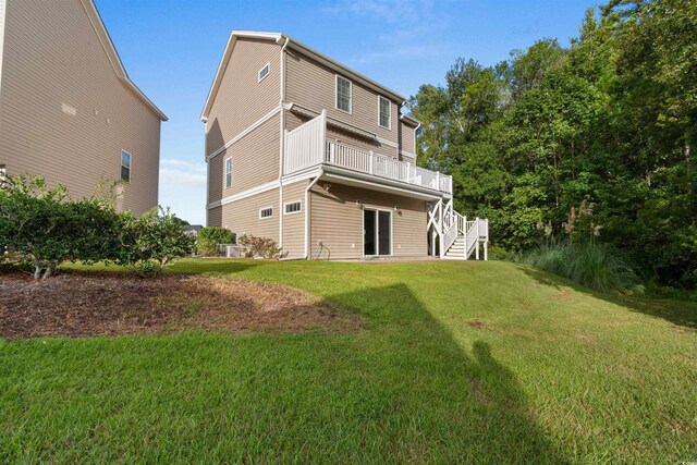 rear view of property featuring a yard