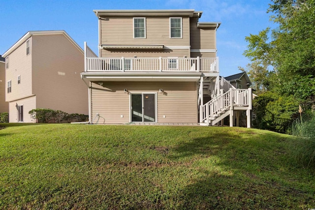 rear view of property with a wooden deck and a lawn