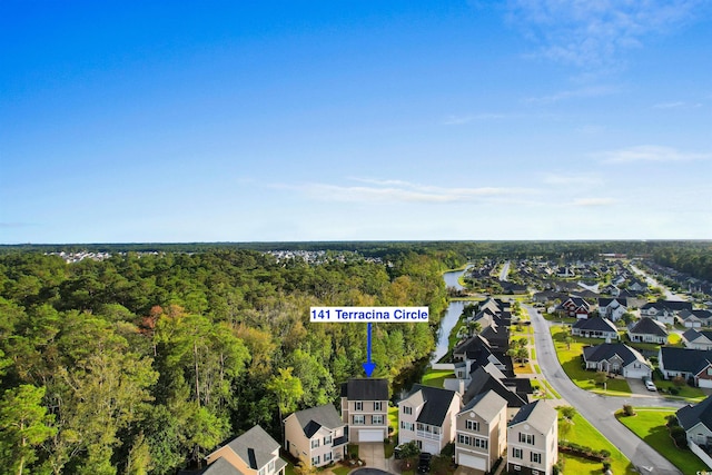 birds eye view of property with a residential view and a forest view