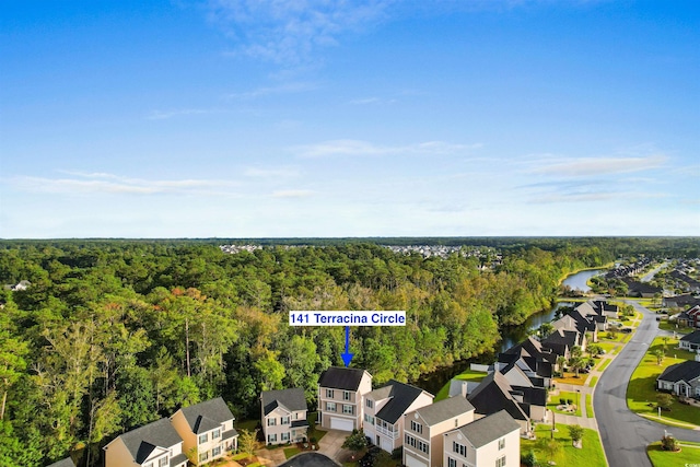 bird's eye view featuring a water view, a forest view, and a residential view