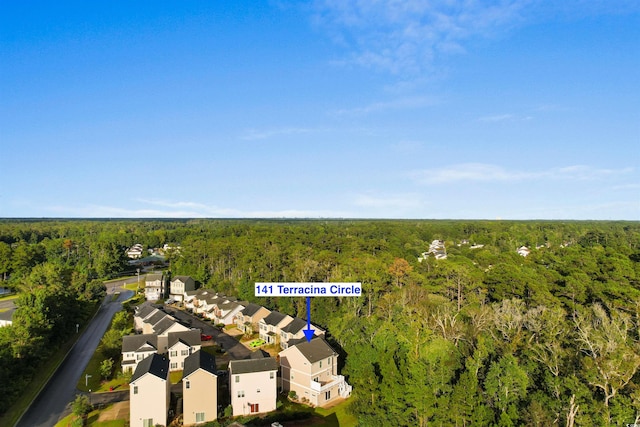 drone / aerial view featuring a wooded view