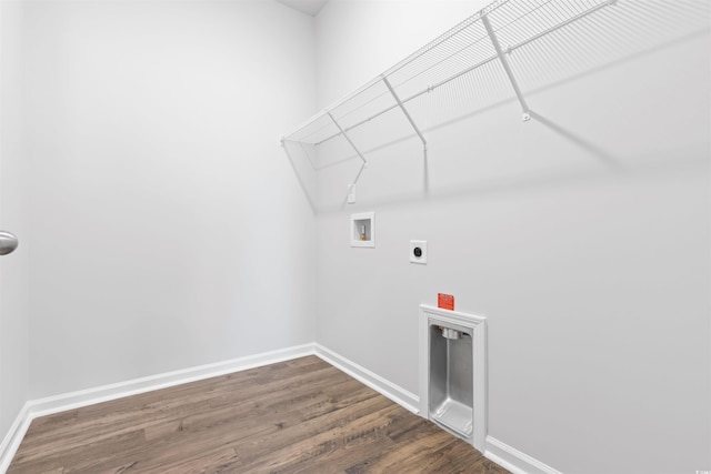 clothes washing area featuring laundry area, baseboards, dark wood-type flooring, hookup for an electric dryer, and washer hookup