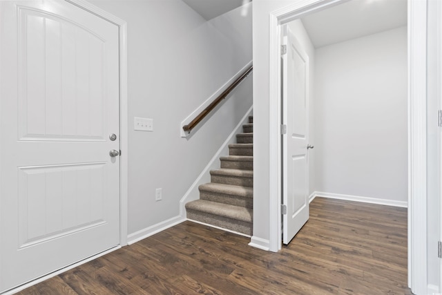 foyer entrance featuring baseboards, stairway, and dark wood-style flooring