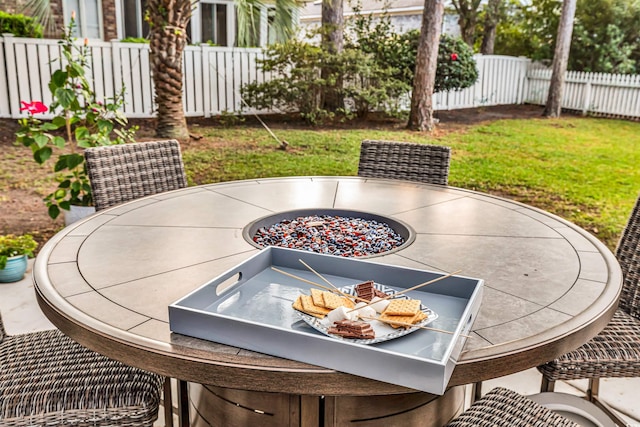 view of patio with a fire pit and fence