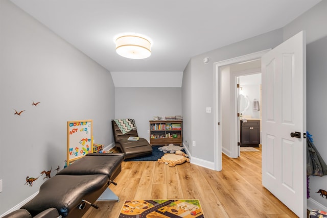 living area featuring light wood-style flooring and baseboards