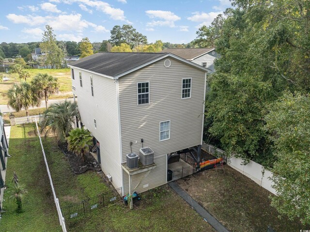 rear view of property featuring central AC