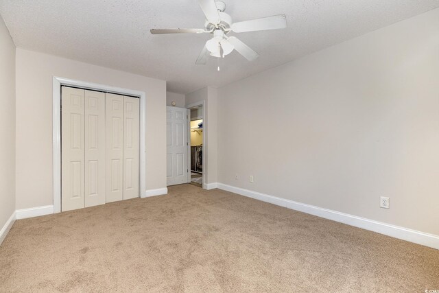 unfurnished bedroom featuring a closet, ceiling fan, carpet, and a textured ceiling